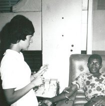 Analice Decker, Medical Technologist, with a blood donor.